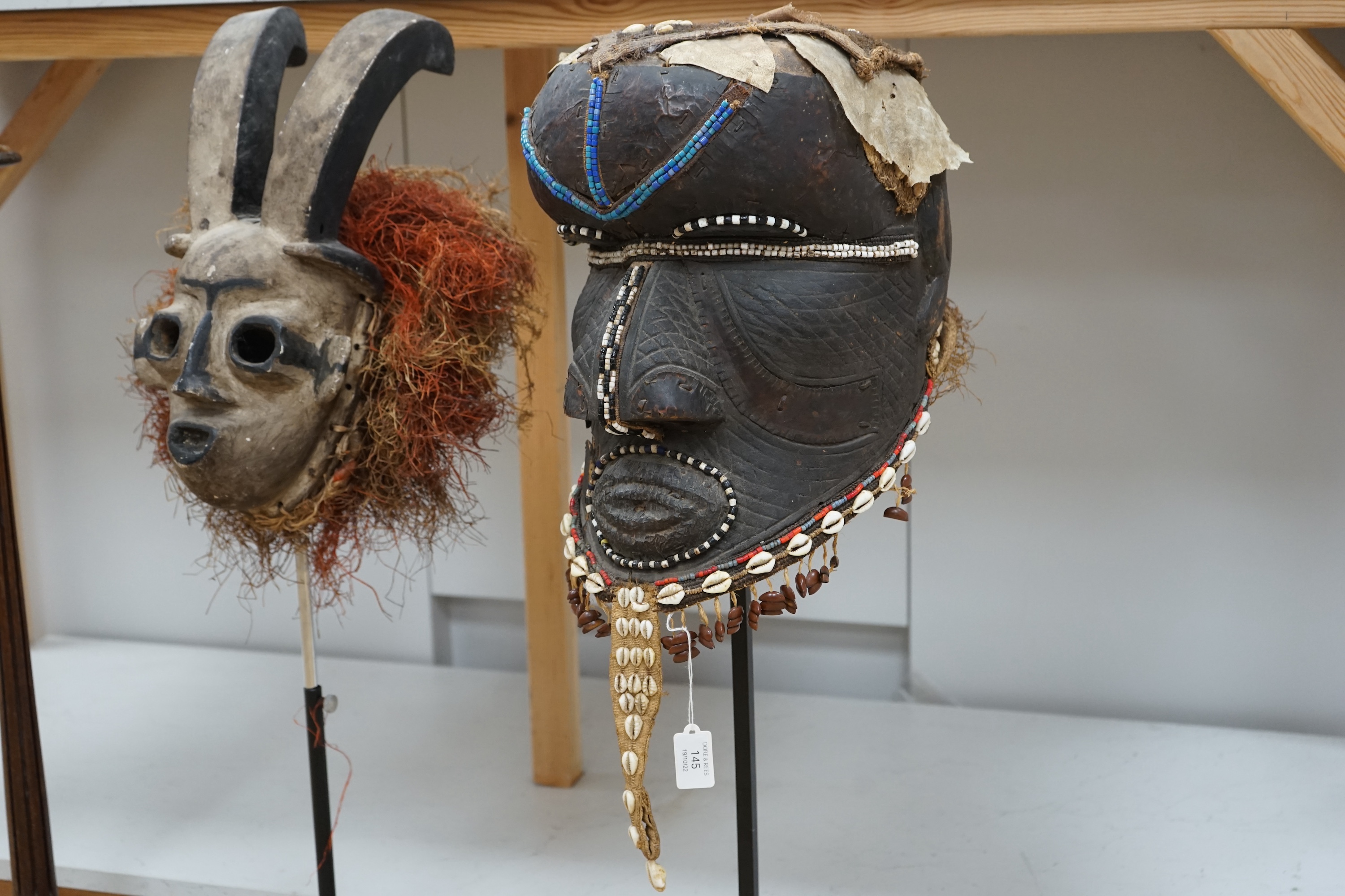 An African Kuba helmet mask and another horned mask, both on stands & one spare. Condition - helmet mask damaged